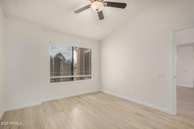 spare room with wood finished floors, baseboards, a ceiling fan, and lofted ceiling