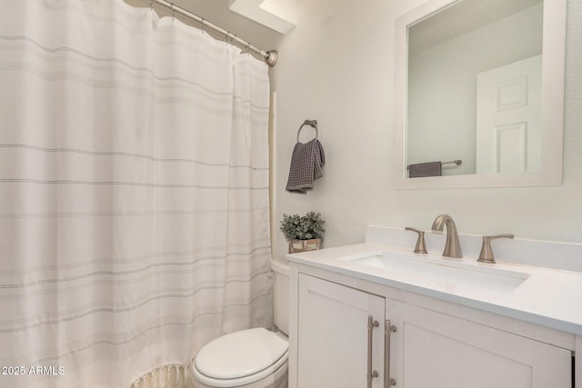 bathroom with toilet and vanity