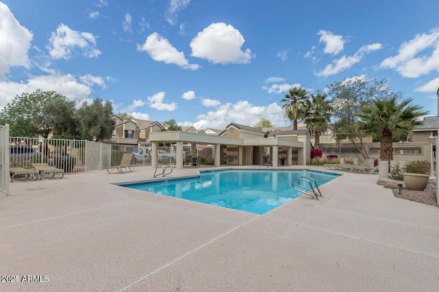 community pool featuring a patio and fence
