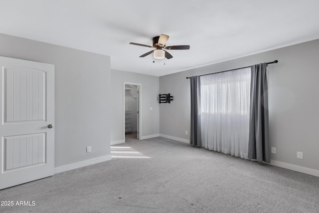 unfurnished room with ceiling fan and light colored carpet