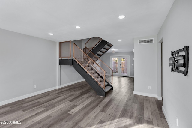 interior space with wood-type flooring and french doors