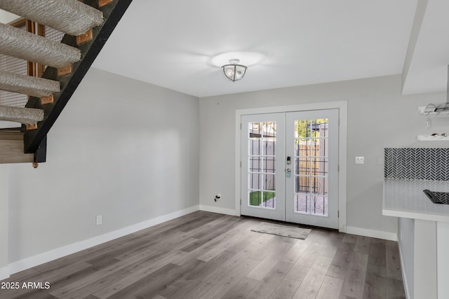 doorway with hardwood / wood-style flooring and french doors