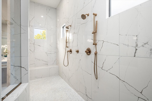 bathroom with a marble finish shower