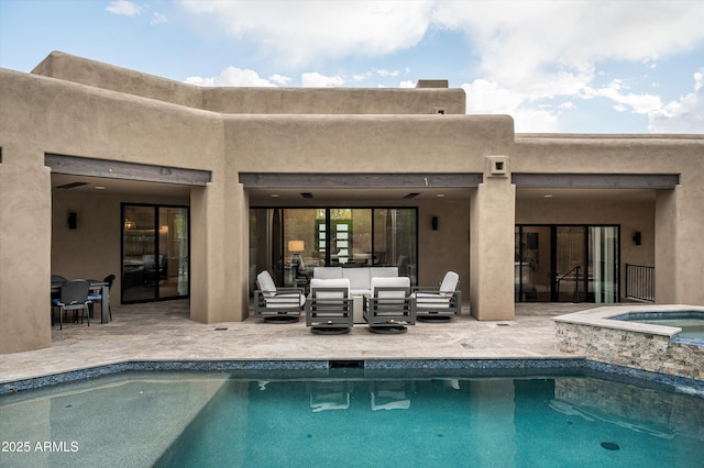 view of swimming pool with outdoor lounge area, a patio, and a pool with connected hot tub