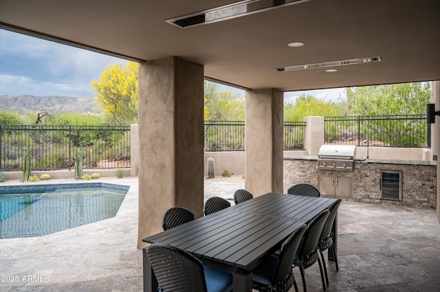 view of pool featuring area for grilling, a patio area, a grill, and a fenced backyard