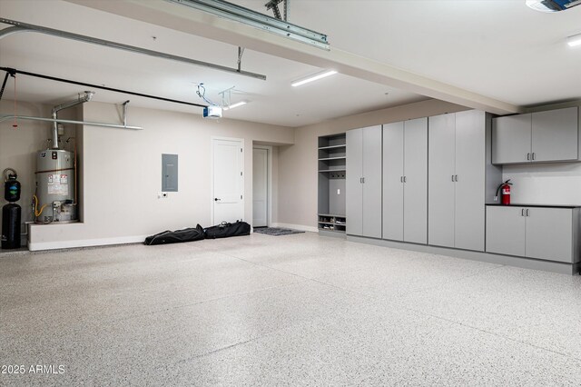 garage featuring gas water heater, electric panel, baseboards, and a garage door opener