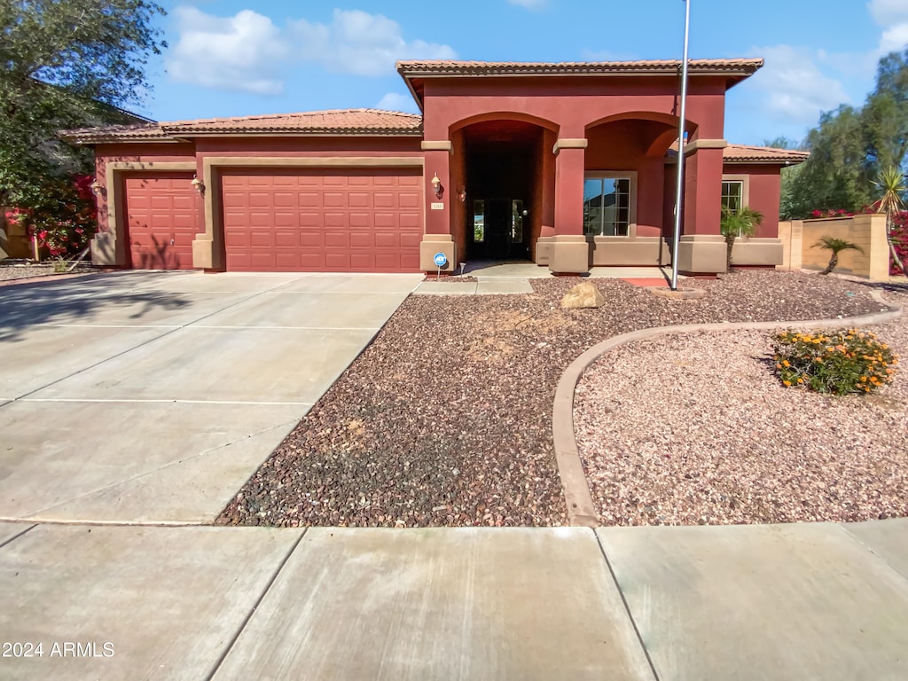 mediterranean / spanish house with a garage