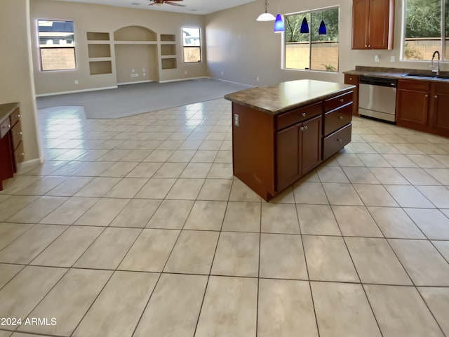 kitchen with sink, a kitchen island, hanging light fixtures, stainless steel dishwasher, and ceiling fan