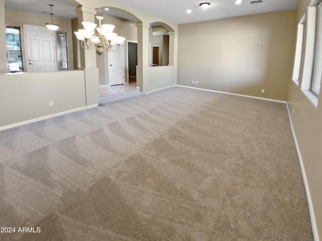 interior space featuring light colored carpet and a notable chandelier