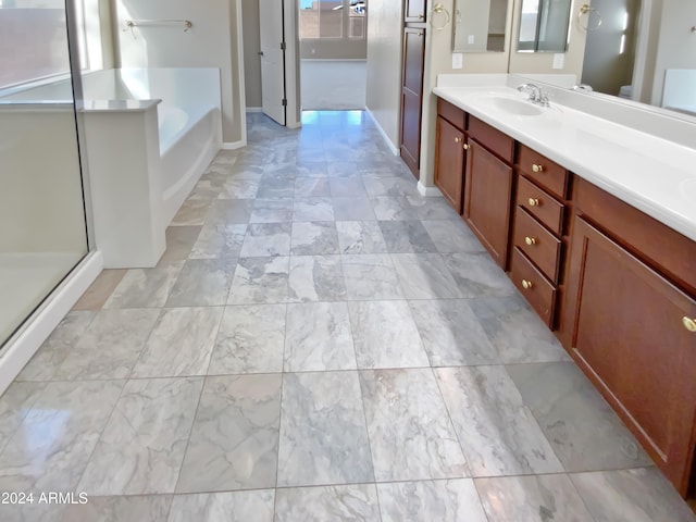 bathroom with vanity and independent shower and bath