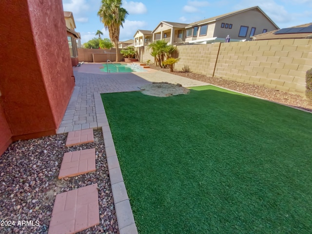 view of yard with a fenced in pool and a patio area