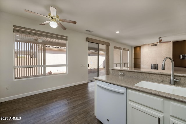 kitchen with white cabinets, white dishwasher, a wealth of natural light, and sink