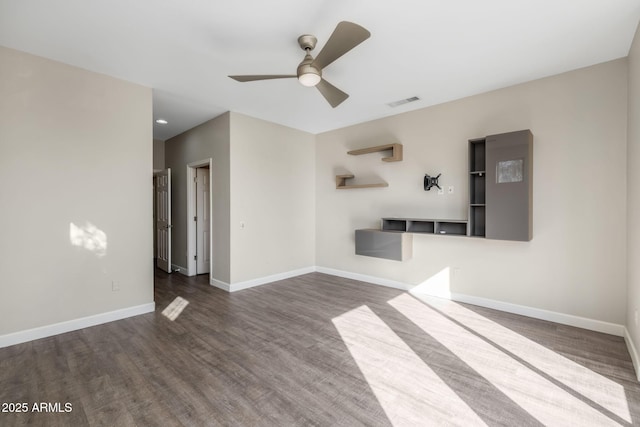 unfurnished living room featuring ceiling fan and dark hardwood / wood-style floors