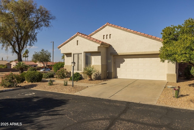 mediterranean / spanish-style house with a garage