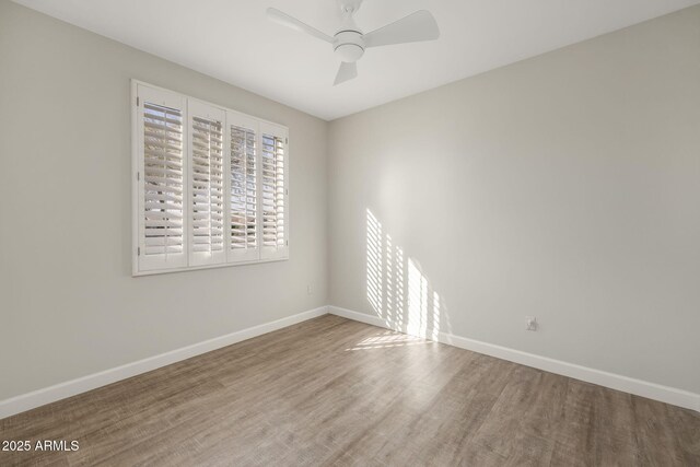 spare room with ceiling fan and hardwood / wood-style floors