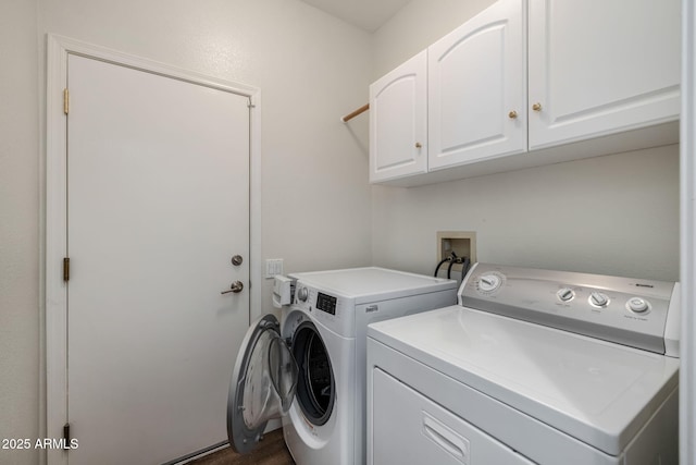 washroom with dark hardwood / wood-style flooring, cabinets, and independent washer and dryer