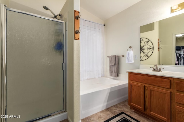 11318 S Hopi Dr, Goodyear, AZ 85338 - bathroom featuring vaulted ceiling, a shower stall, a bath, vanity, and tile patterned floors