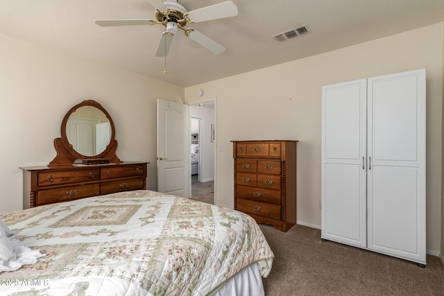 11318 S Hopi Dr, Goodyear, AZ 85338 - bedroom with dark colored carpet, a ceiling fan, and baseboards