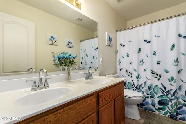11318 S Hopi Dr, Goodyear, AZ 85338 - full bath with toilet, double vanity, tile patterned floors, and curtained shower