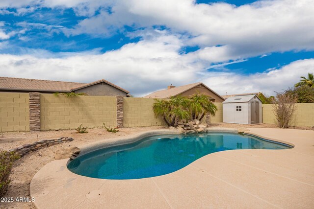 11318 S Hopi Dr, Goodyear, AZ 85338 - view of swimming pool with a shed, a fenced backyard, a patio area, and an outbuilding