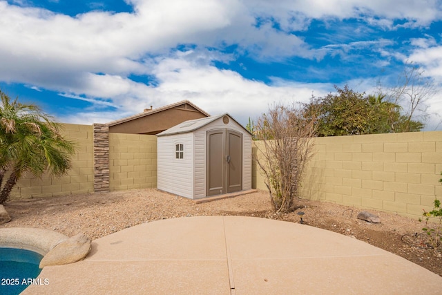 11318 S Hopi Dr, Goodyear, AZ 85338 - view of patio with a storage shed, a fenced backyard, and an outdoor structure