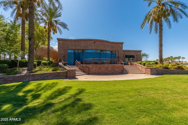 11318 S Hopi Dr, Goodyear, AZ 85338 - back of property featuring stairs, a lawn, and a patio