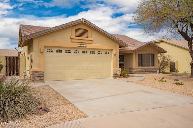 11318 S Hopi Dr, Goodyear, AZ 85338 - single story home featuring stone siding, a garage, stucco siding, and concrete driveway