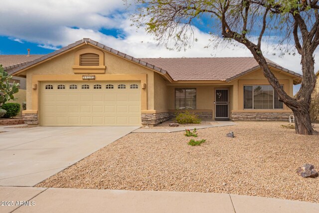 11318 S Hopi Dr, Goodyear, AZ 85338 - ranch-style house featuring stone siding, an attached garage, stucco siding, concrete driveway, and a tiled roof