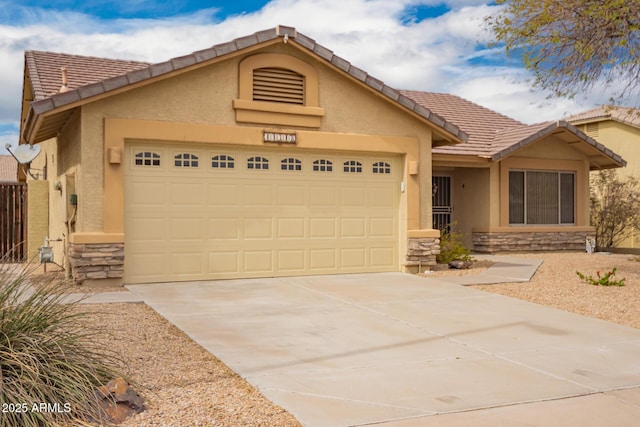 11318 S Hopi Dr, Goodyear, AZ 85338 - ranch-style home with stone siding, stucco siding, an attached garage, a tile roof, and concrete driveway