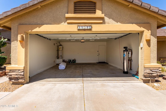11318 S Hopi Dr, Goodyear, AZ 85338 - garage with strapped water heater and concrete driveway