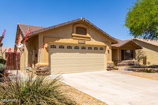 11318 S Hopi Dr, Goodyear, AZ 85338 - single story home featuring an attached garage, concrete driveway, stone siding, and stucco siding