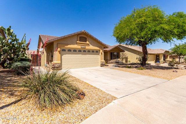 11318 S Hopi Dr, Goodyear, AZ 85338 - ranch-style house featuring stucco siding, an attached garage, and driveway