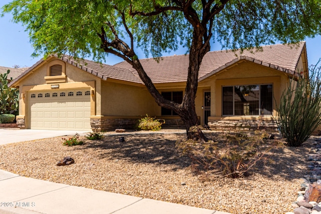 11318 S Hopi Dr, Goodyear, AZ 85338 - single story home featuring stucco siding, a garage, driveway, and stone siding