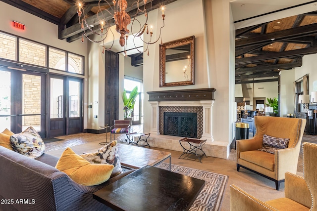 11318 S Hopi Dr, Goodyear, AZ 85338 - living area with beamed ceiling, a fireplace, a towering ceiling, wood ceiling, and a chandelier