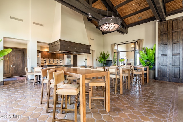 11318 S Hopi Dr, Goodyear, AZ 85338 - dining space with high vaulted ceiling, beamed ceiling, and wooden ceiling