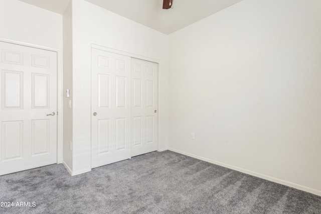 unfurnished bedroom featuring a closet, ceiling fan, and carpet flooring