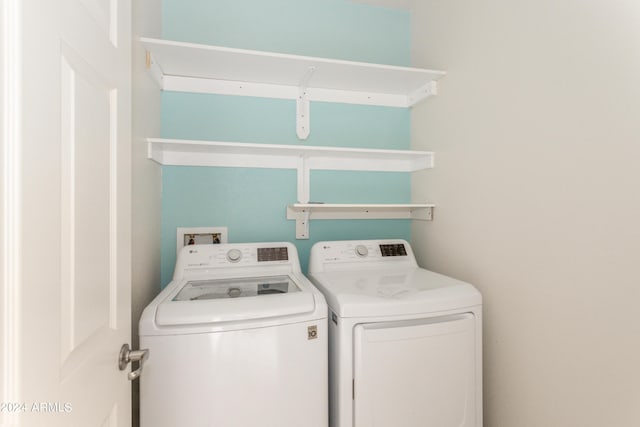 clothes washing area with laundry area and washing machine and clothes dryer