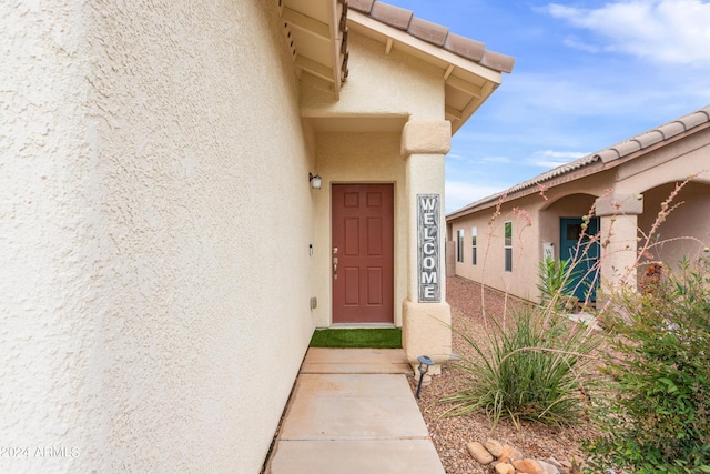 entrance to property featuring stucco siding