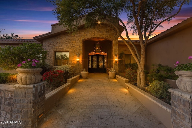 exterior entry at dusk with french doors