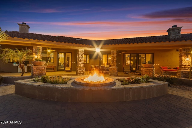 view of front of property with an outdoor fire pit and a patio