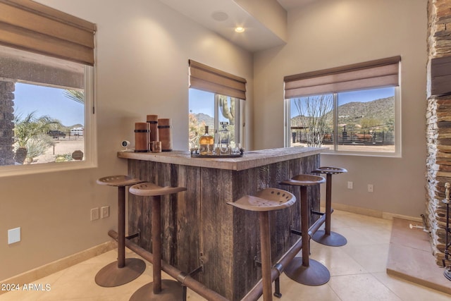 bar with plenty of natural light and light tile floors