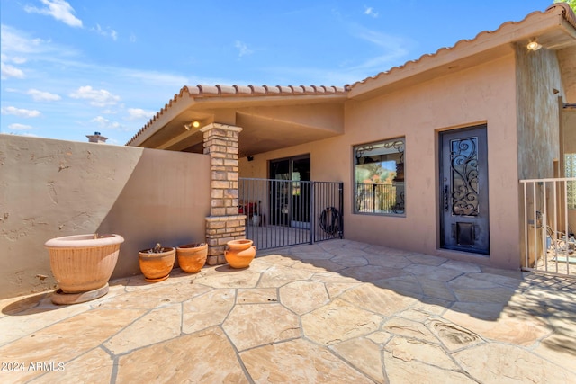 property entrance featuring a patio area