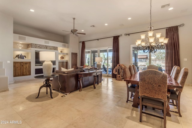 tiled dining room featuring ceiling fan with notable chandelier, plenty of natural light, and built in features