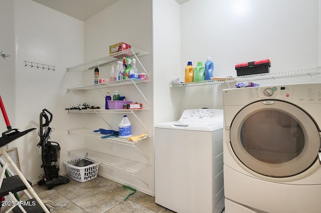 clothes washing area with washing machine and dryer