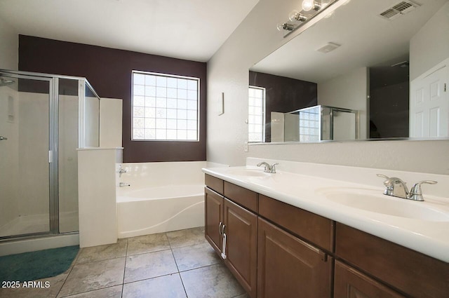 bathroom featuring independent shower and bath, vanity, and tile patterned floors