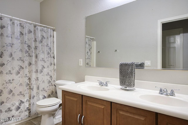 bathroom featuring tile patterned flooring, vanity, curtained shower, and toilet