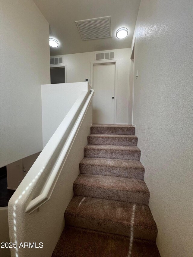 stairs with a textured wall