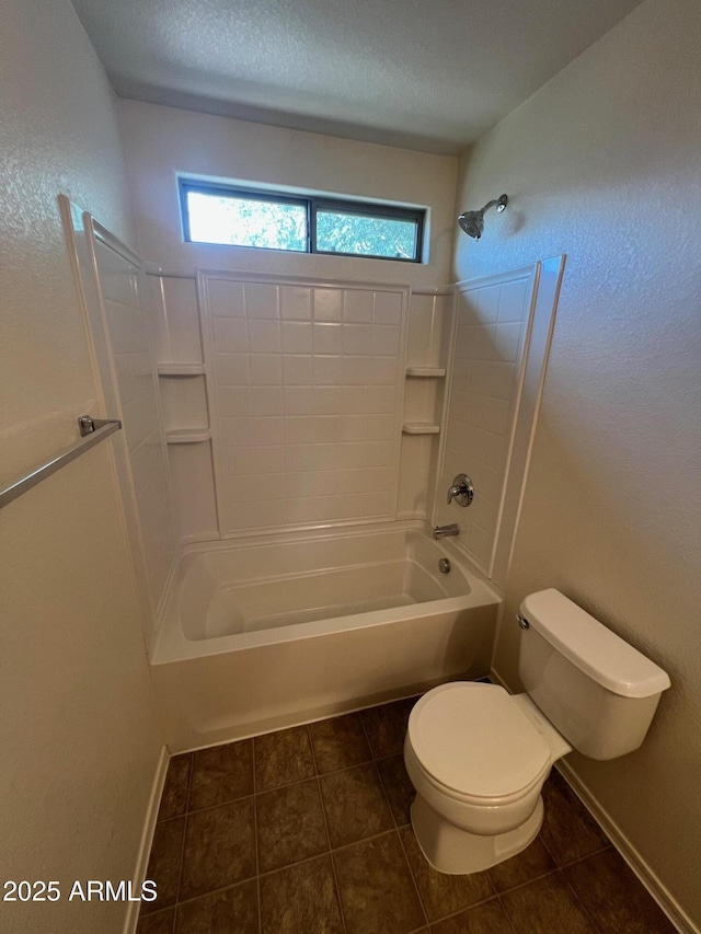 bathroom with toilet, tile patterned flooring, shower / bathtub combination, baseboards, and a textured ceiling