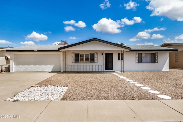 ranch-style home featuring covered porch, concrete driveway, a shingled roof, and a garage