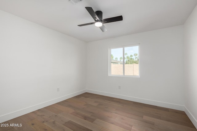 spare room with ceiling fan and hardwood / wood-style flooring